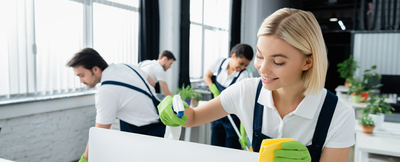 people cleaning computers and desks