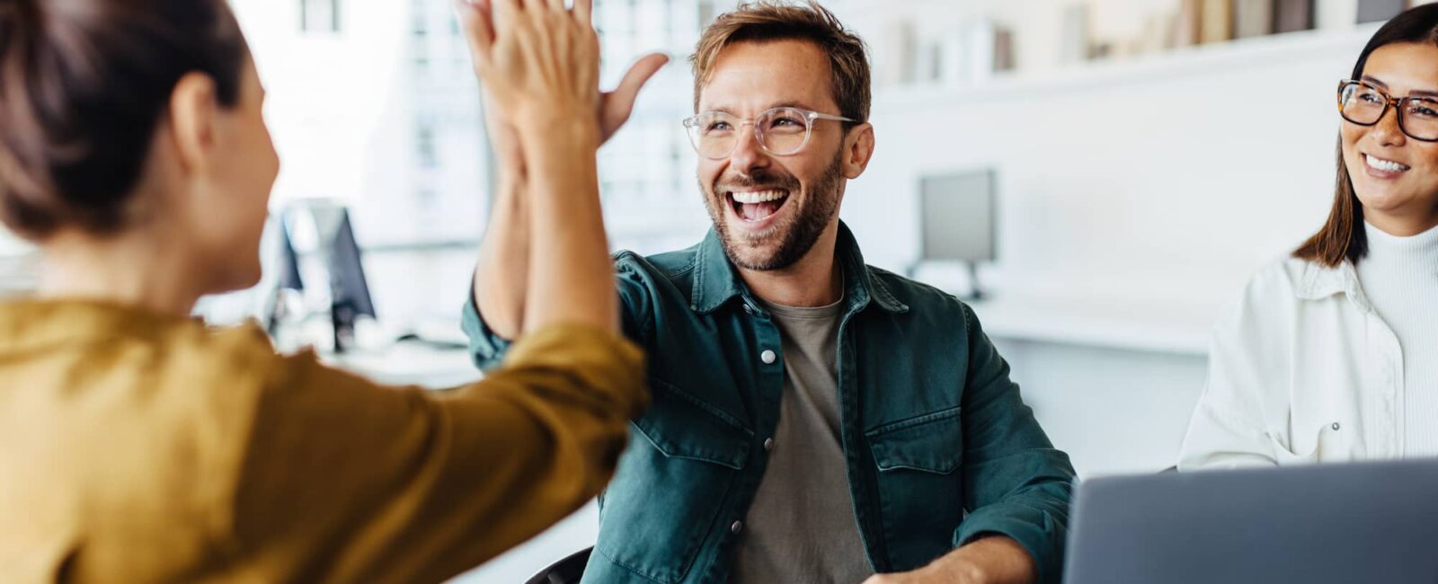 Colleagues sharing positive experience in the office